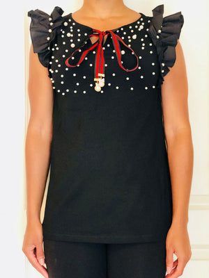 Black sleeveless shirt with ruffle detailing, pearl embellishment and red/black ribbon.