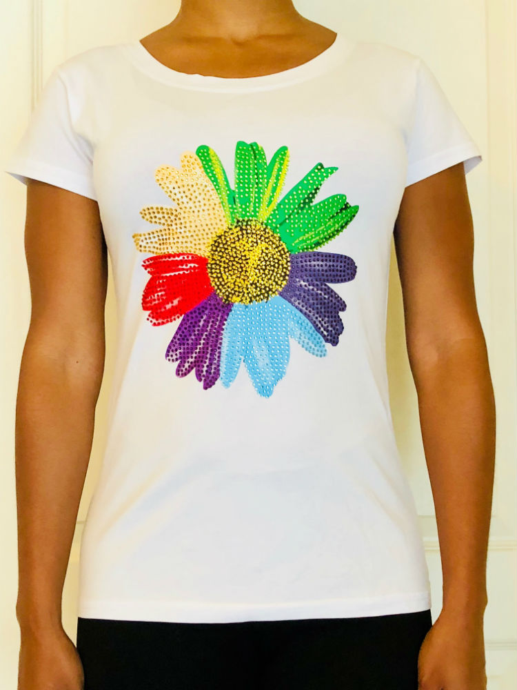 White short-sleeved T-shirt with colored bedazzling flower design.