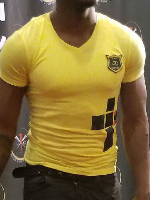 Yellow short-sleeved shirt with black/red boxed cross.
